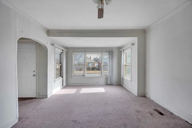 a view of a big room with closet and a ceiling fan