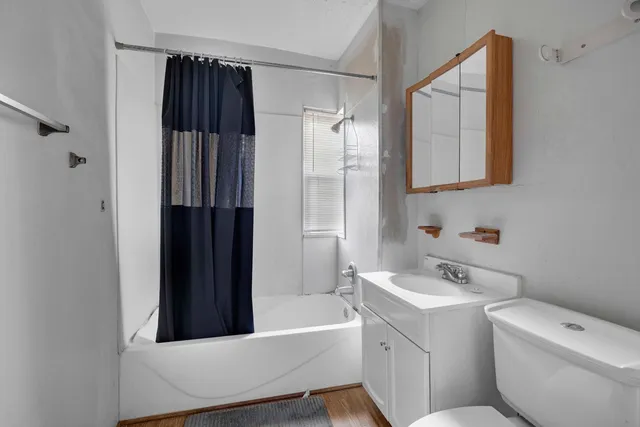 a view of a room with wooden floor and windows