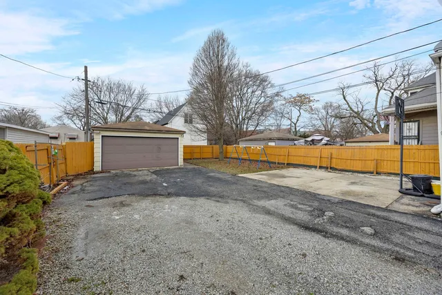 a front view of a house with a yard and potted plants