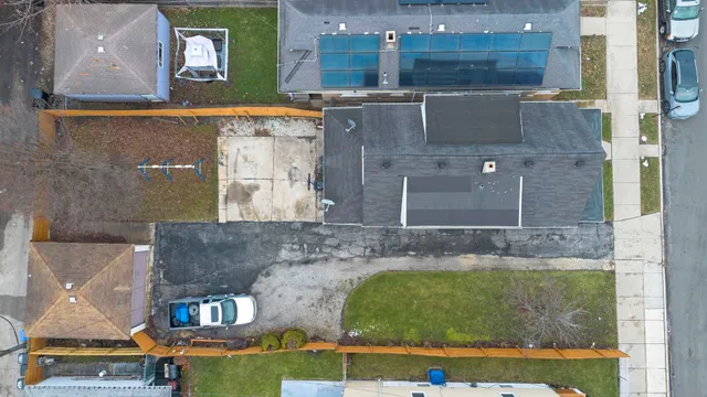 an aerial view of a house with a yard