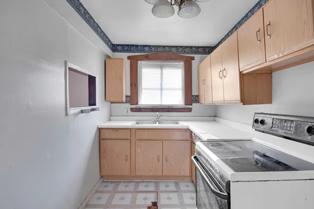 a kitchen with a sink stove and cabinets