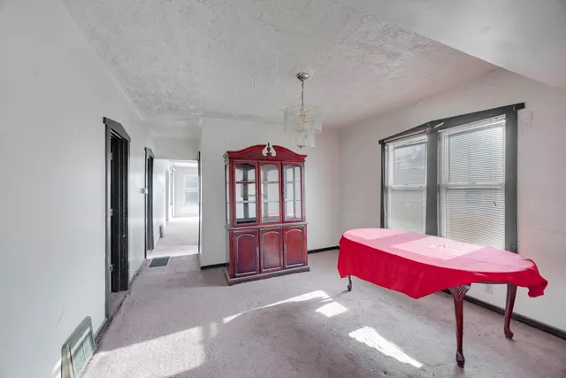 a bed room with a bed and windows