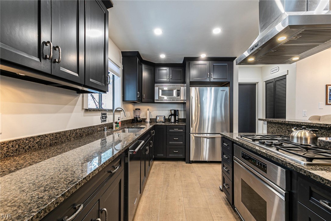 771 Golfers Pass Road Incline Village, NV 89451 - Photo 11 of 26 a kitchen with stainless steel appliances granite countertop a refrigerator a stove and a sink