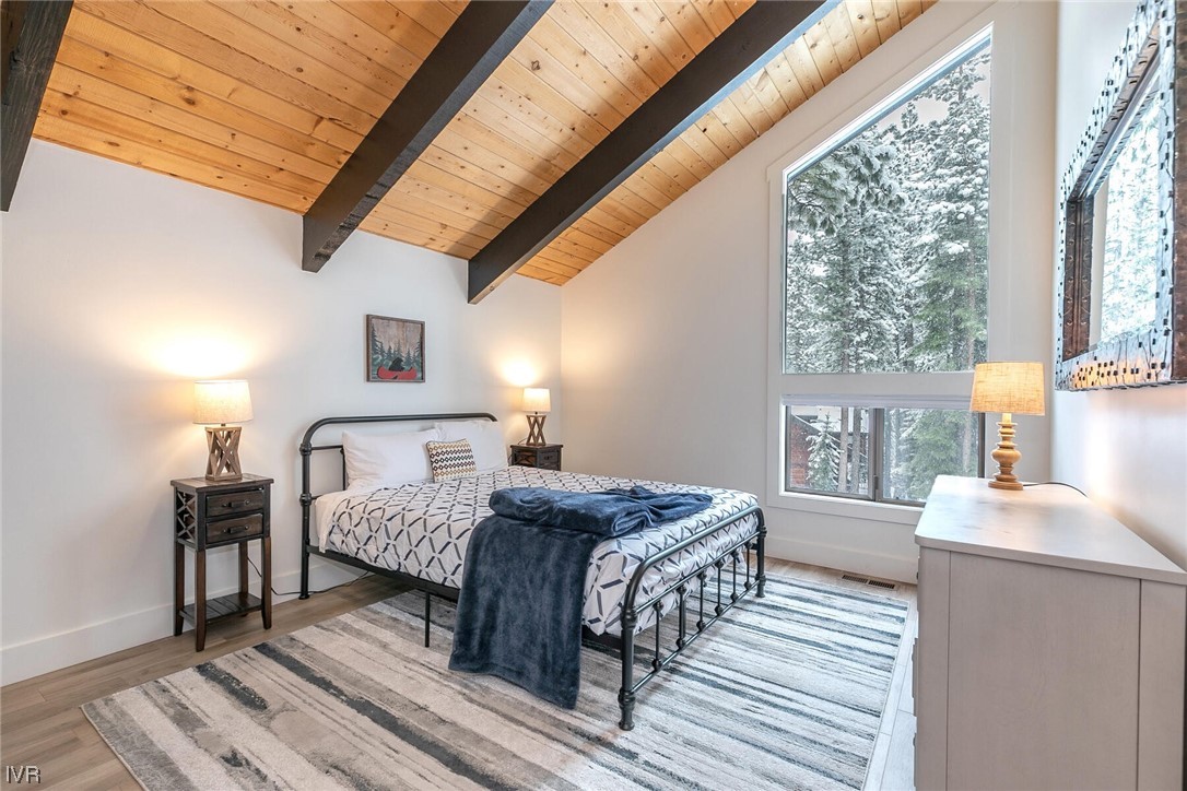 771 Golfers Pass Road Incline Village, NV 89451 - Photo 14 of 26 a bedroom with a bed next to a window with a dresser