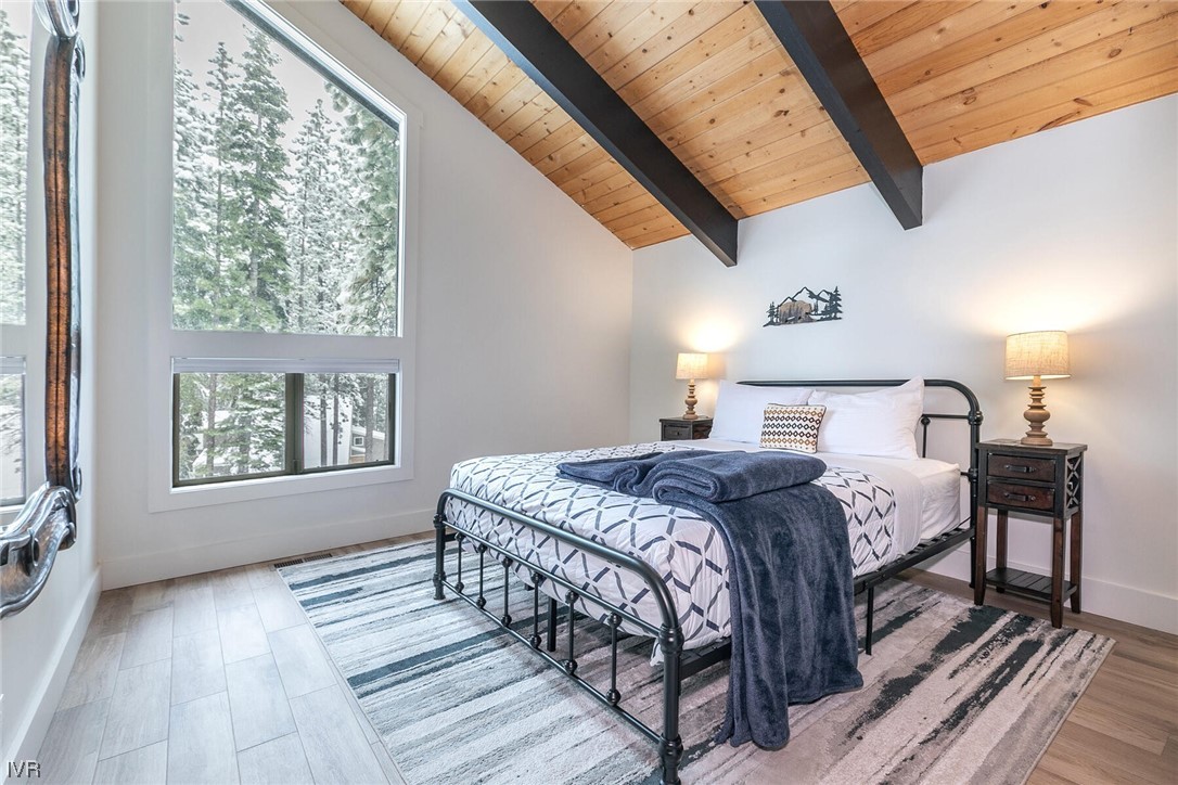 771 Golfers Pass Road Incline Village, NV 89451 - Photo 16 of 26 a bedroom with a bed a mirror and a window