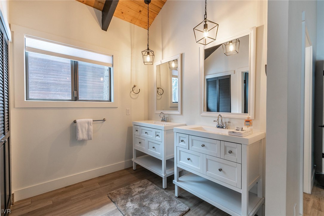 771 Golfers Pass Road Incline Village, NV 89451 - Photo 21 of 26 a bathroom with a double vanity sink toilet mirror and window