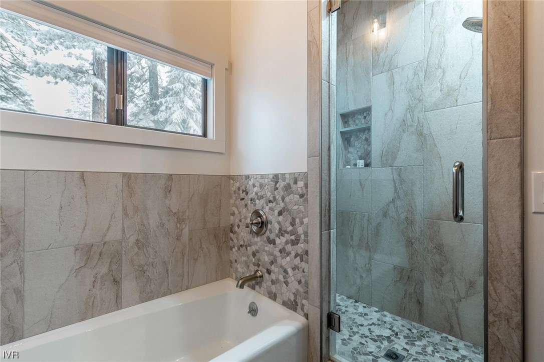 771 Golfers Pass Road Incline Village, NV 89451 - Photo 22 of 26 a bathroom with a bathtub and window