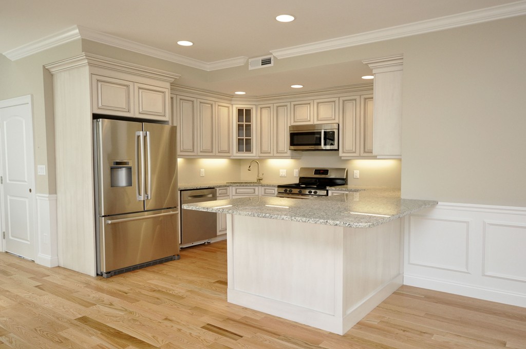 a kitchen with stainless steel appliances granite countertop a refrigerator stove microwave and sink