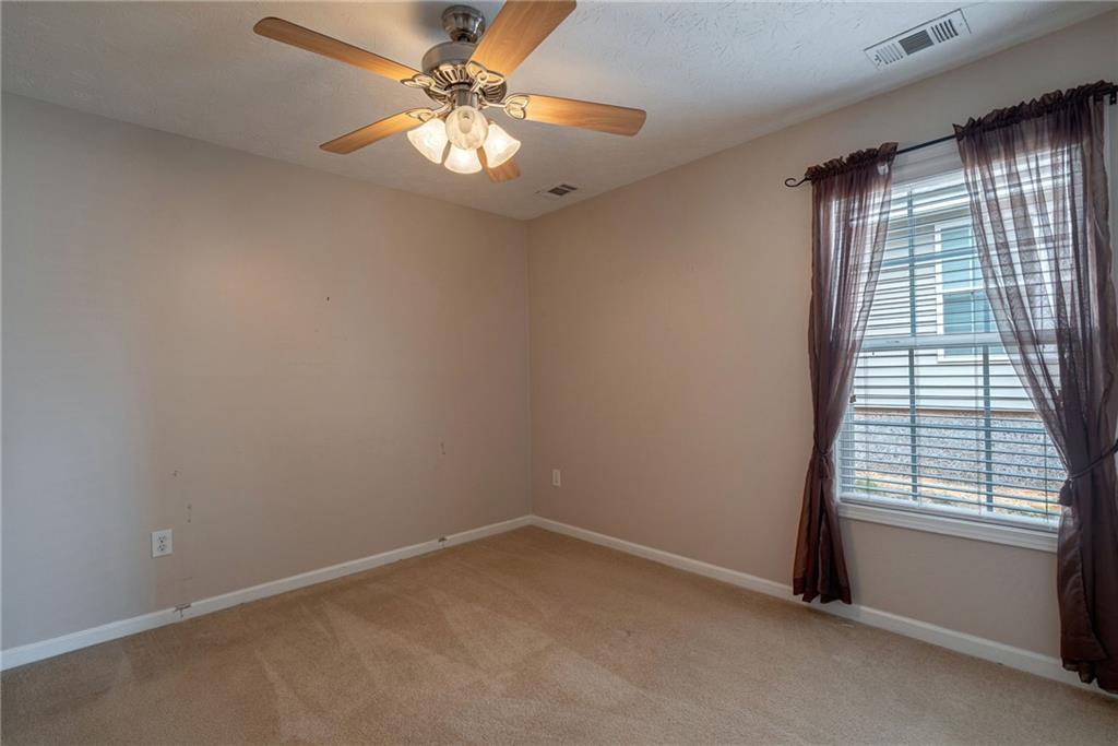 245 Memory Lane Winder, GA 30680 - Photo 35 of 62 an empty room with windows and fan