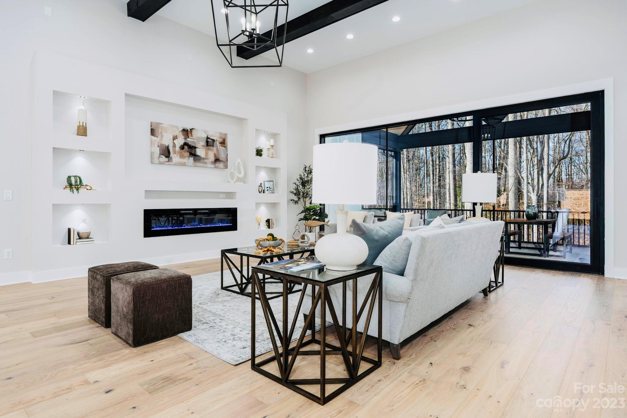 8527 Fieldstone Drive Terrell, NC 28682 - Photo 14 of 48 a living room with furniture a large window and a chandelier