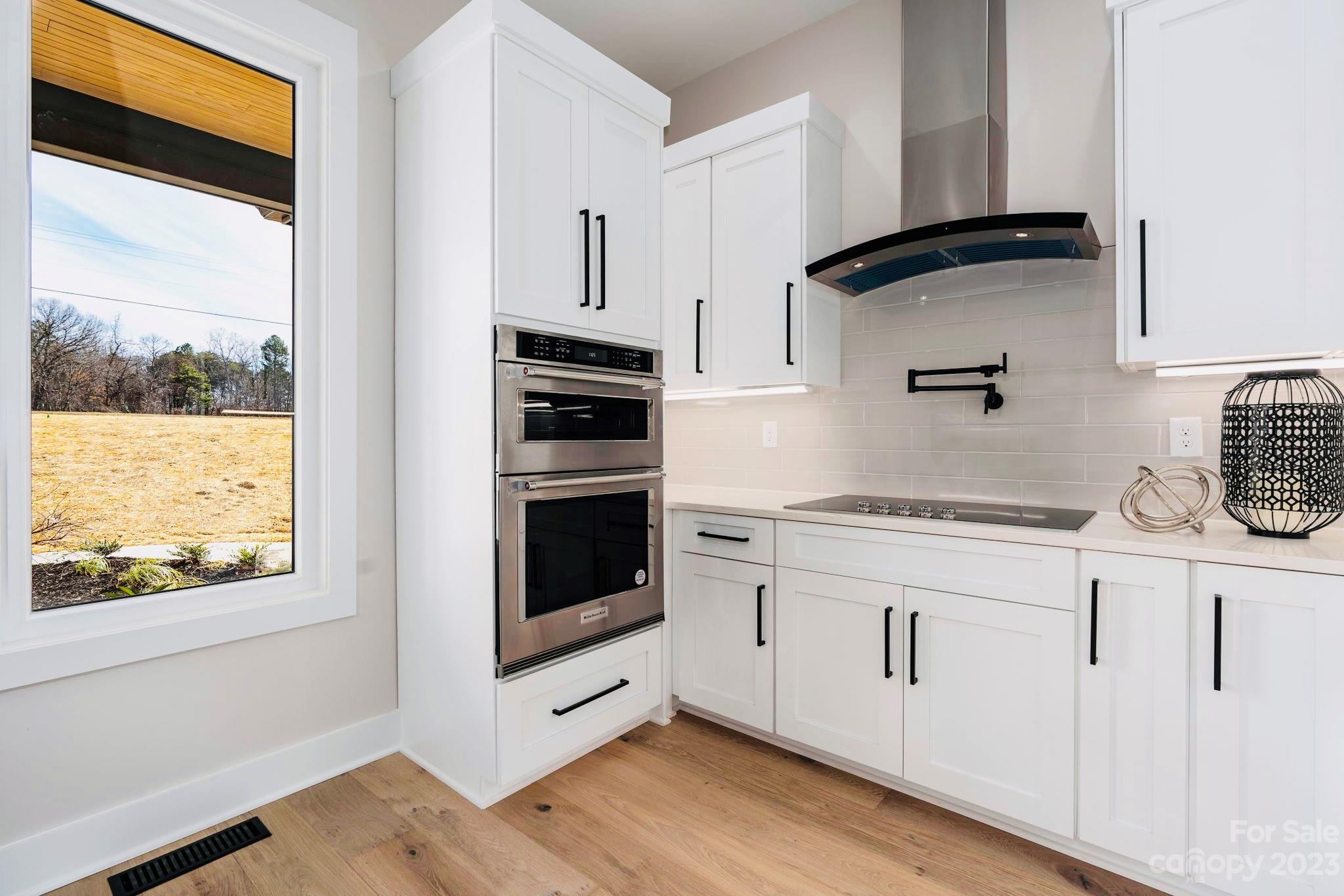 8527 Fieldstone Drive Terrell, NC 28682 - Photo 21 of 48 a kitchen with granite countertop white cabinets and white appliances