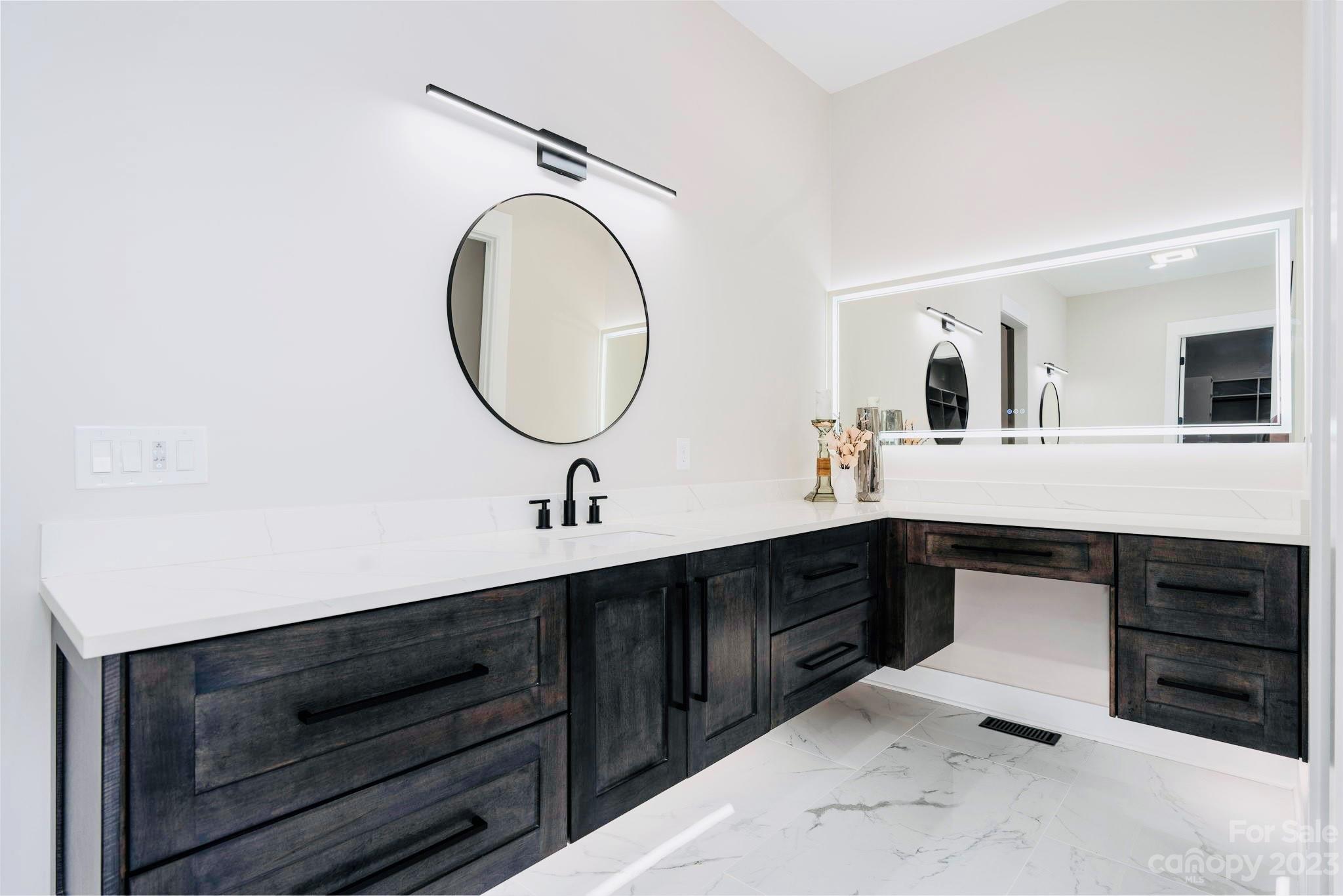 8527 Fieldstone Drive Terrell, NC 28682 - Photo 26 of 48 a spacious bathroom with a double vanity sink and a mirror