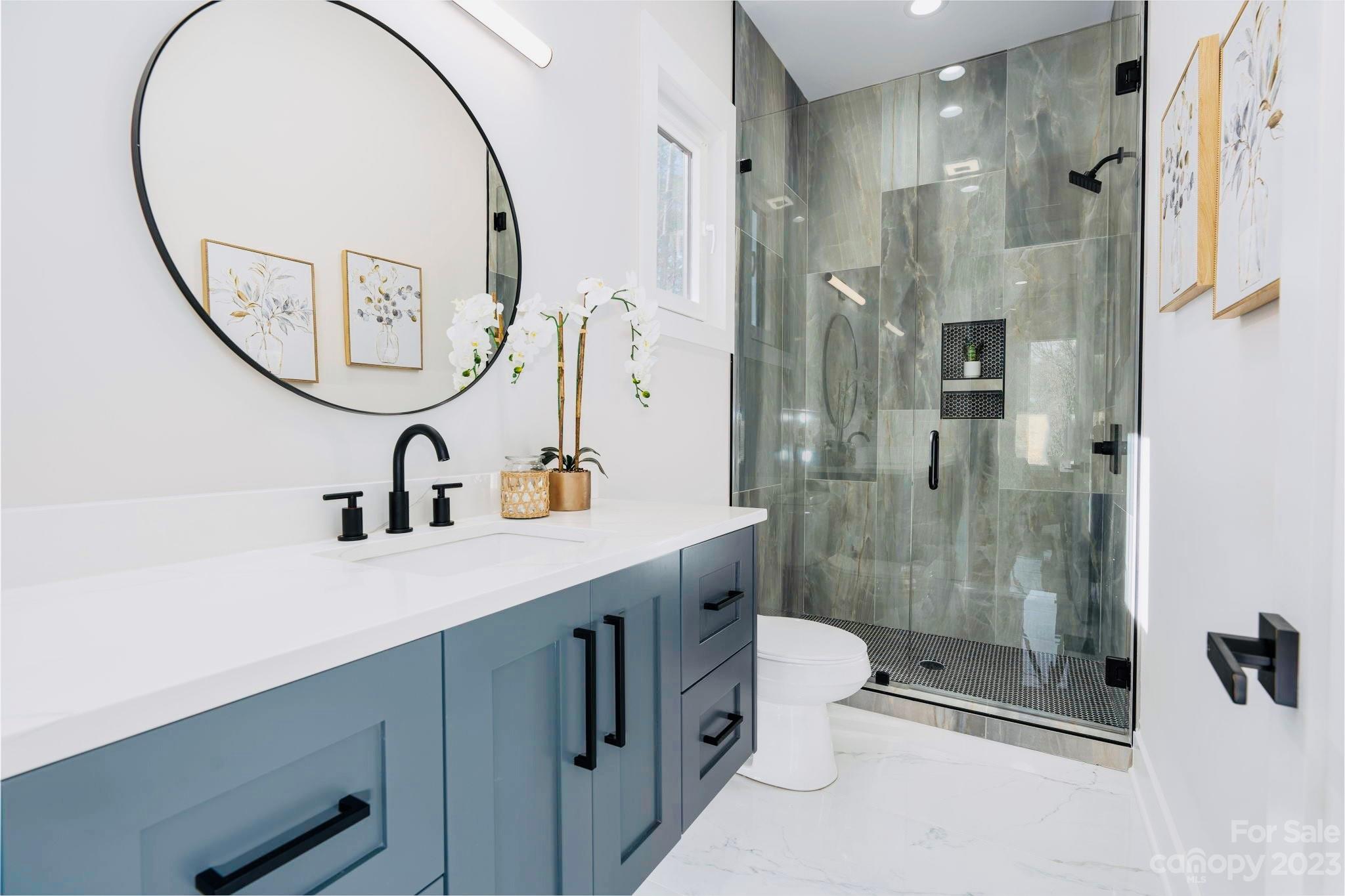 8527 Fieldstone Drive Terrell, NC 28682 - Photo 32 of 48 a bathroom with a mirror a sink and a mirror