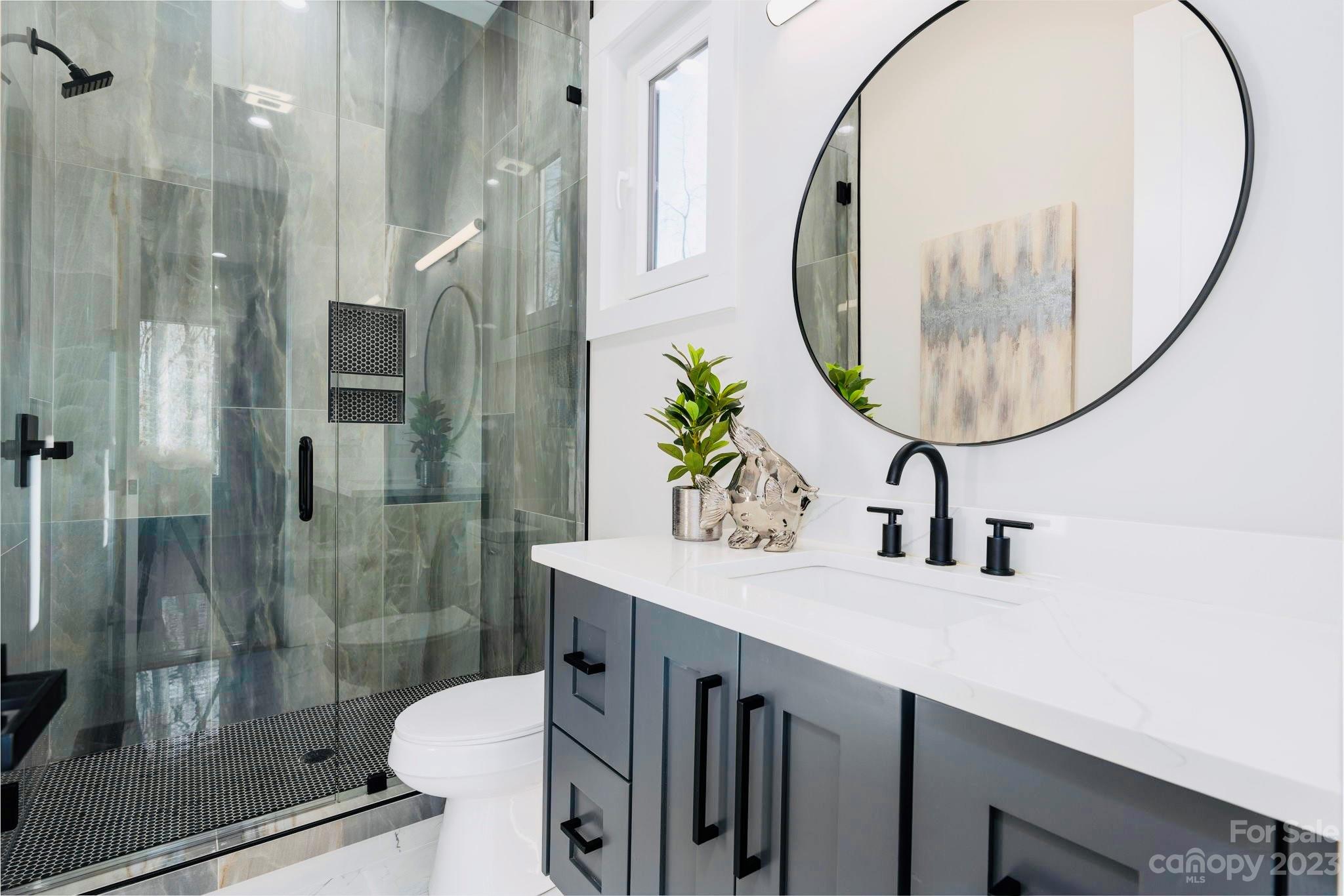 8527 Fieldstone Drive Terrell, NC 28682 - Photo 35 of 48 a bathroom with a sink a toilet and a mirror
