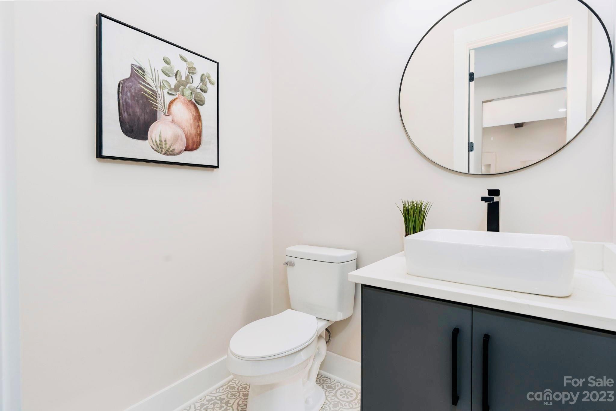 8527 Fieldstone Drive Terrell, NC 28682 - Photo 37 of 48 a bathroom with a toilet a sink and mirror