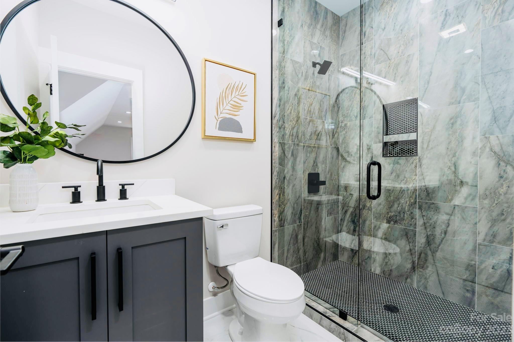 8527 Fieldstone Drive Terrell, NC 28682 - Photo 41 of 48 a bathroom with a granite countertop toilet sink and shower