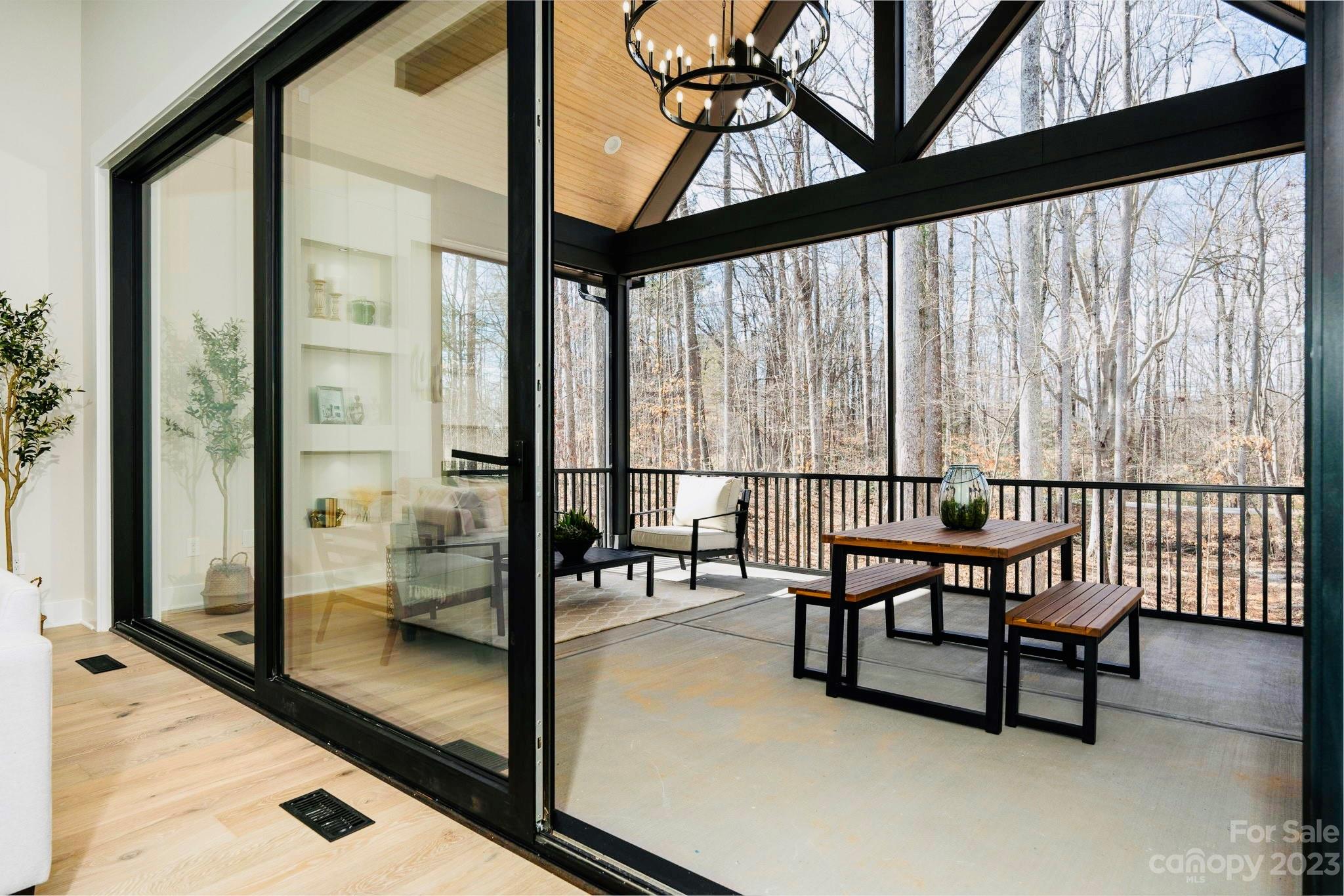 8527 Fieldstone Drive Terrell, NC 28682 - Photo 45 of 48 a view of a porch with chairs and floor to ceiling window