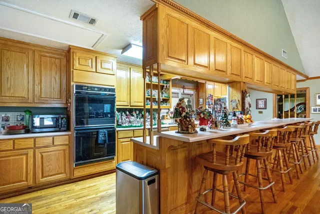 a kitchen with stainless steel appliances granite countertop a sink and cabinets