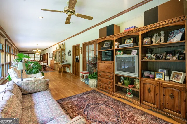 a living room with lots of furniture and book shelf