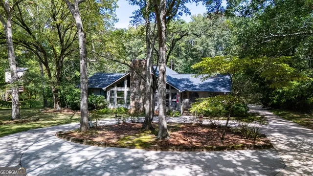 a view of a house with a tree in the yard