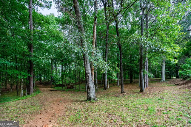 a swimming pool with outdoor seating and yard