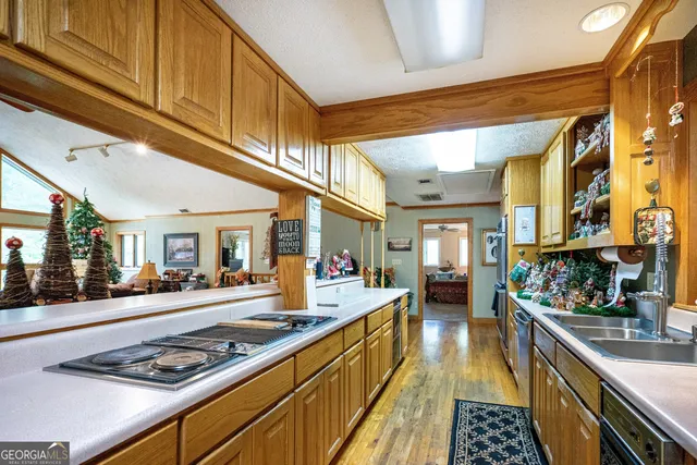 a kitchen with stainless steel appliances kitchen island granite countertop a stove and cabinets