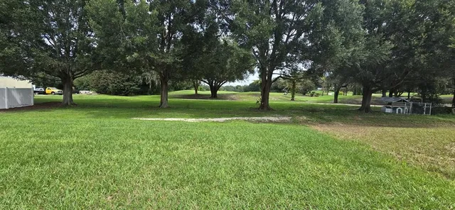 a big yard with lots of green space and trees