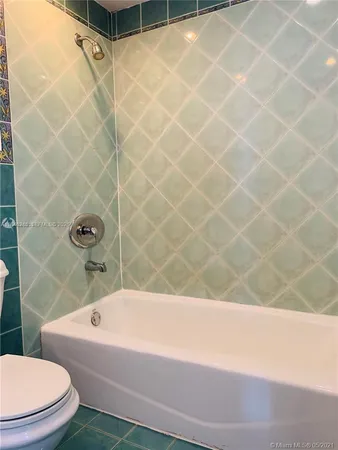 a bathroom with a bathtub and a toilet