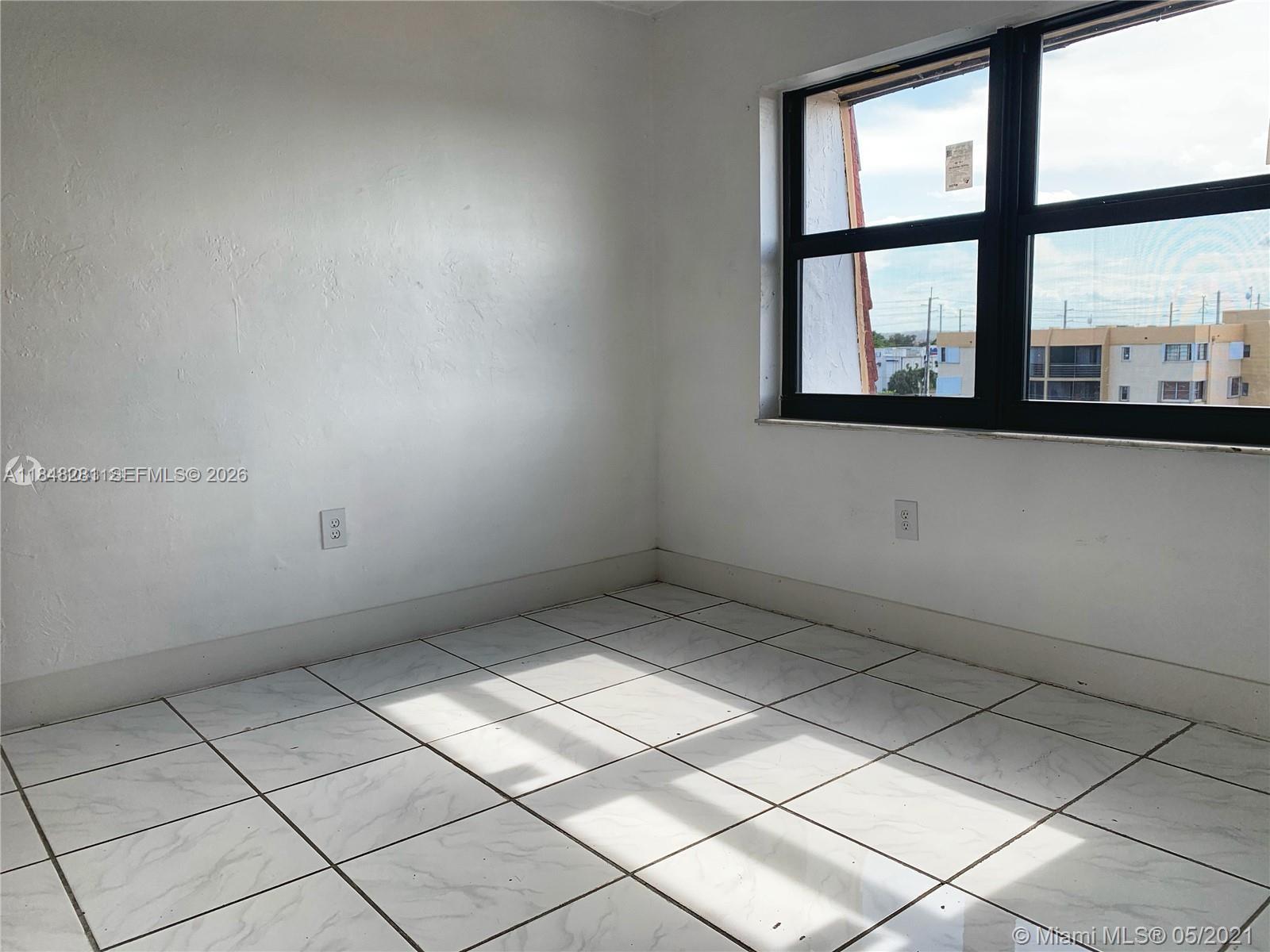 1325 West 68th Street, Unit 514 Hialeah, FL 33014 - Photo 18 of 20 an empty room with windows