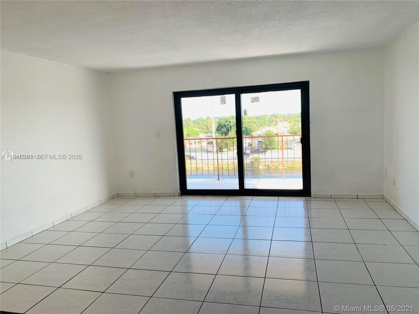 1325 West 68th Street, Unit 514 Hialeah, FL 33014 - Photo 5 of 20 a view of an empty room with a window