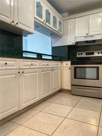 a kitchen with cabinets and appliances