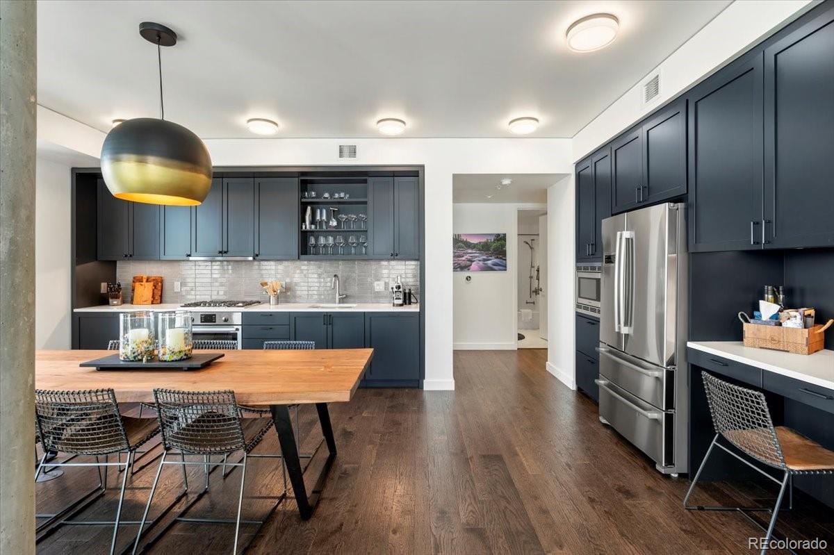 1750 Wewatta Street, Unit 1701 Denver, CO 80202 - Photo 13 of 35 a kitchen with stainless steel appliances granite countertop a sink refrigerator and cabinets