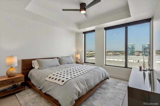 a bedroom with a bed and large window