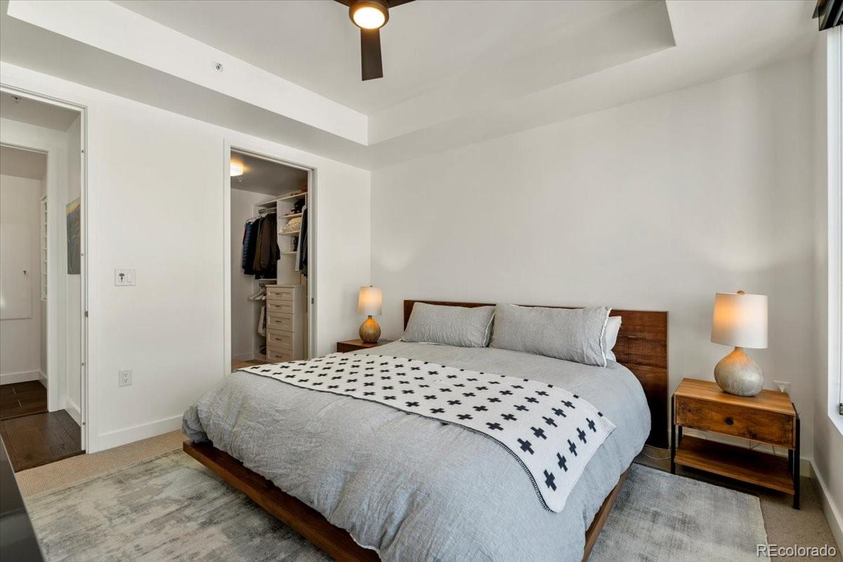 1750 Wewatta Street, Unit 1701 Denver, CO 80202 - Photo 16 of 35 a bedroom with a bed and a lamp
