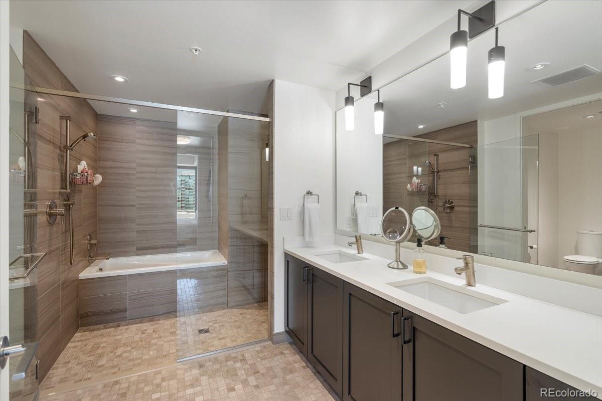 1750 Wewatta Street, Unit 1701 Denver, CO 80202 - Photo 17 of 35 a bathroom with a bathtub shower sink vanity and toilet