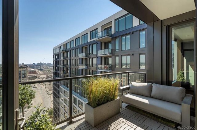 a balcony with furniture and a book shelf