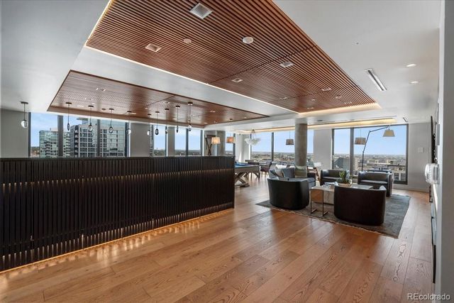 a living room with lots of furniture and wooden floor