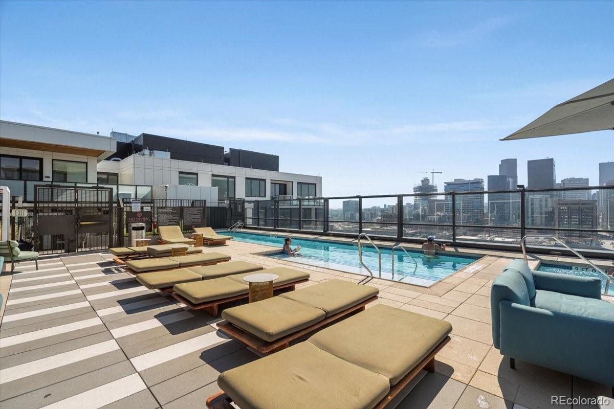 1750 Wewatta Street, Unit 1701 Denver, CO 80202 - Photo 26 of 35 a view of a patio with couches dining table and chairs with wooden floor