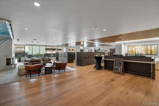 a living room with lots of furniture and kitchen