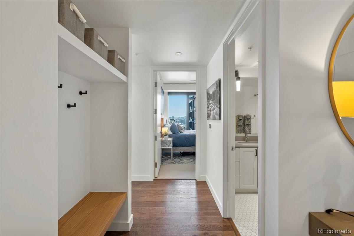 1750 Wewatta Street, Unit 1701 Denver, CO 80202 - Photo 3 of 35 a view of a hallway with wooden floor and a living room