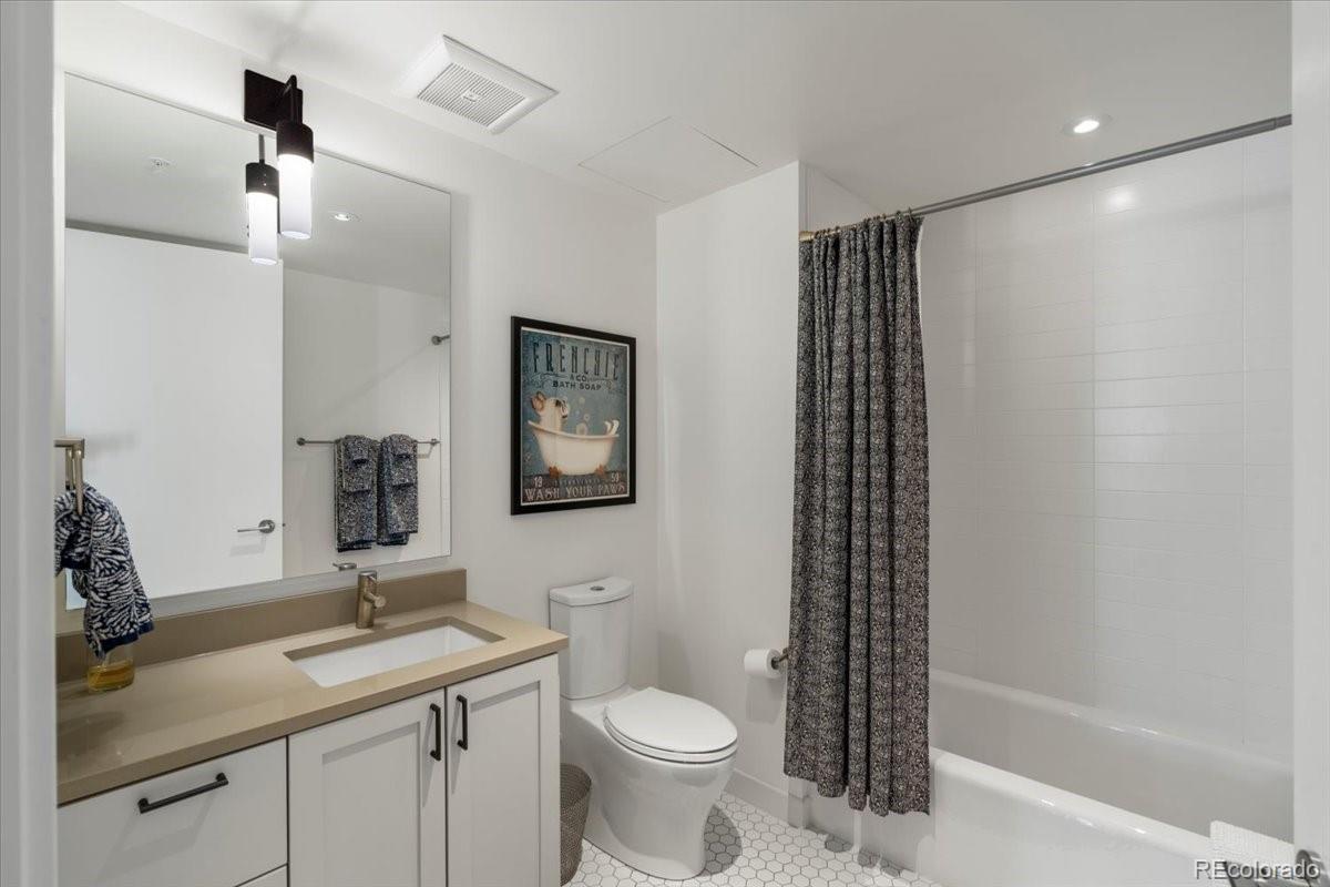 1750 Wewatta Street, Unit 1701 Denver, CO 80202 - Photo 4 of 35 a bathroom with a sink toilet and shower