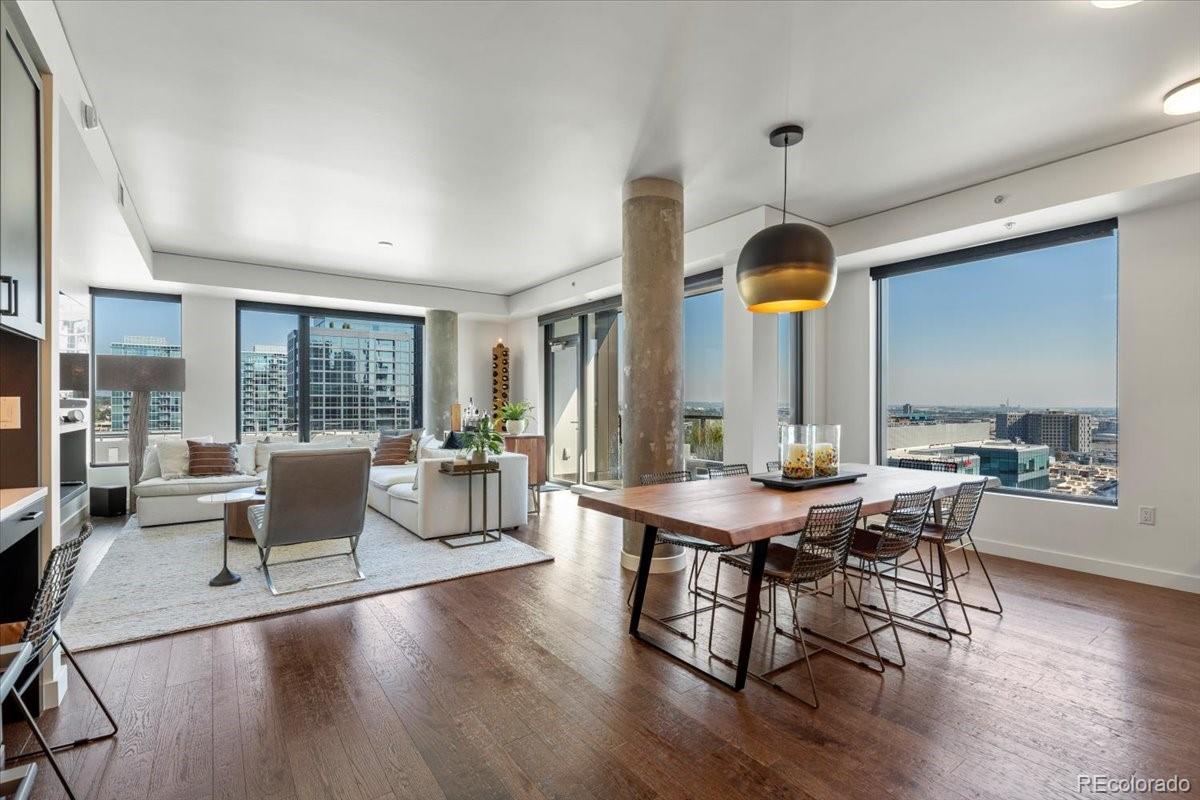 1750 Wewatta Street, Unit 1701 Denver, CO 80202 - Photo 7 of 35 a view of a dining room with furniture window and wooden floor