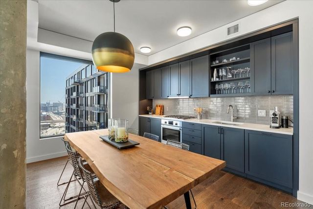 a kitchen with a table chairs sink and cabinets