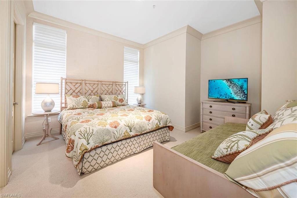 868 5th Avenue South, Unit 3A Naples, FL 34102 - Photo 14 of 21 a bedroom with a bed and a flat screen tv
