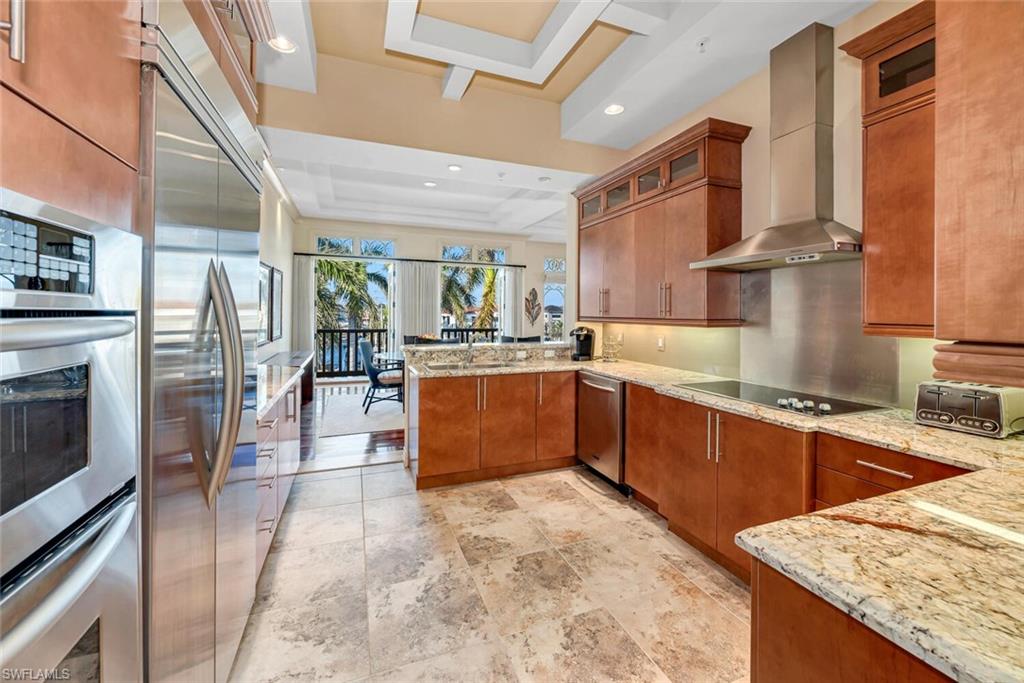 868 5th Avenue South, Unit 3A Naples, FL 34102 - Photo 7 of 21 a large kitchen with stainless steel appliances granite countertop a stove and cabinets