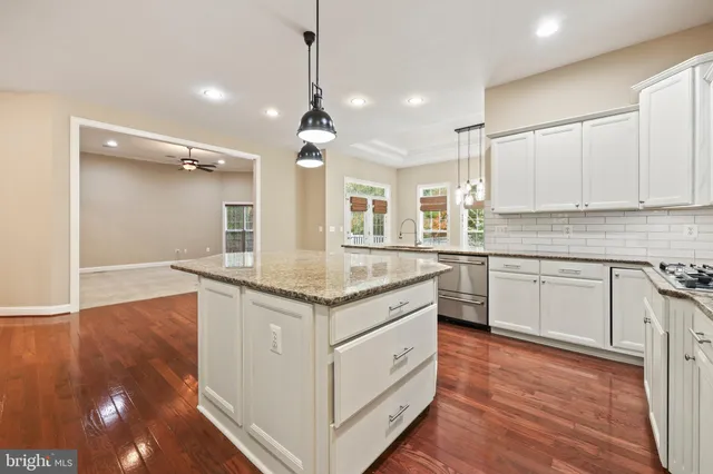 a view of an empty room with a fireplace and a window