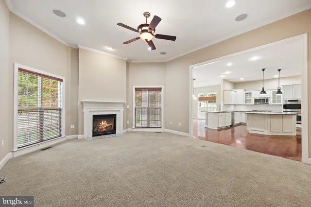 a view of an empty room and a ceiling fan