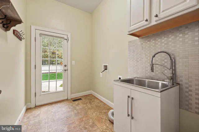 a view of empty room with fireplace and fan