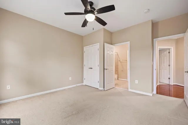 a view of an empty room with a fireplace and a window