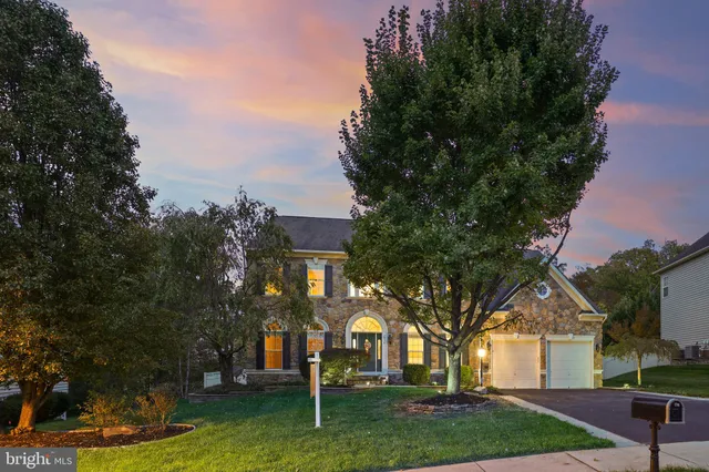 a view of a livingroom with a chandelier furniture and windows